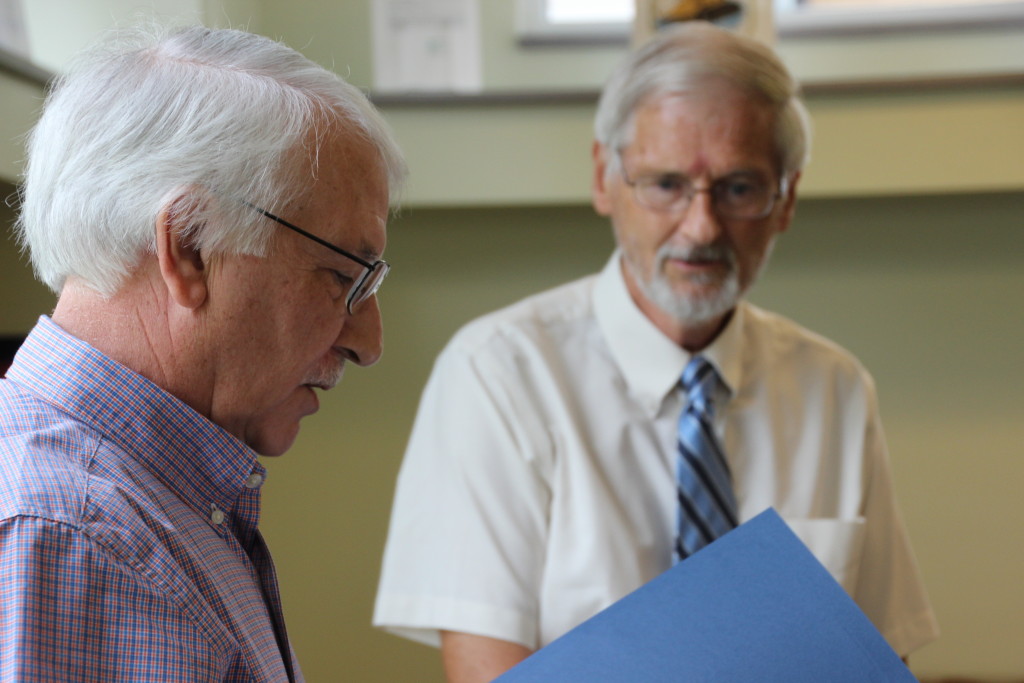 West Virginia State Delegate Walter Duke (R-Berkeley, 61) reads the Certificate of Recognition presented by the Senate of West Virginia to Roger Engle at a ceremony held at Hedgesville Public Library on June 20, 2015 to honor the award-winning, West Virginia author. | Photo by Stephanie Engle